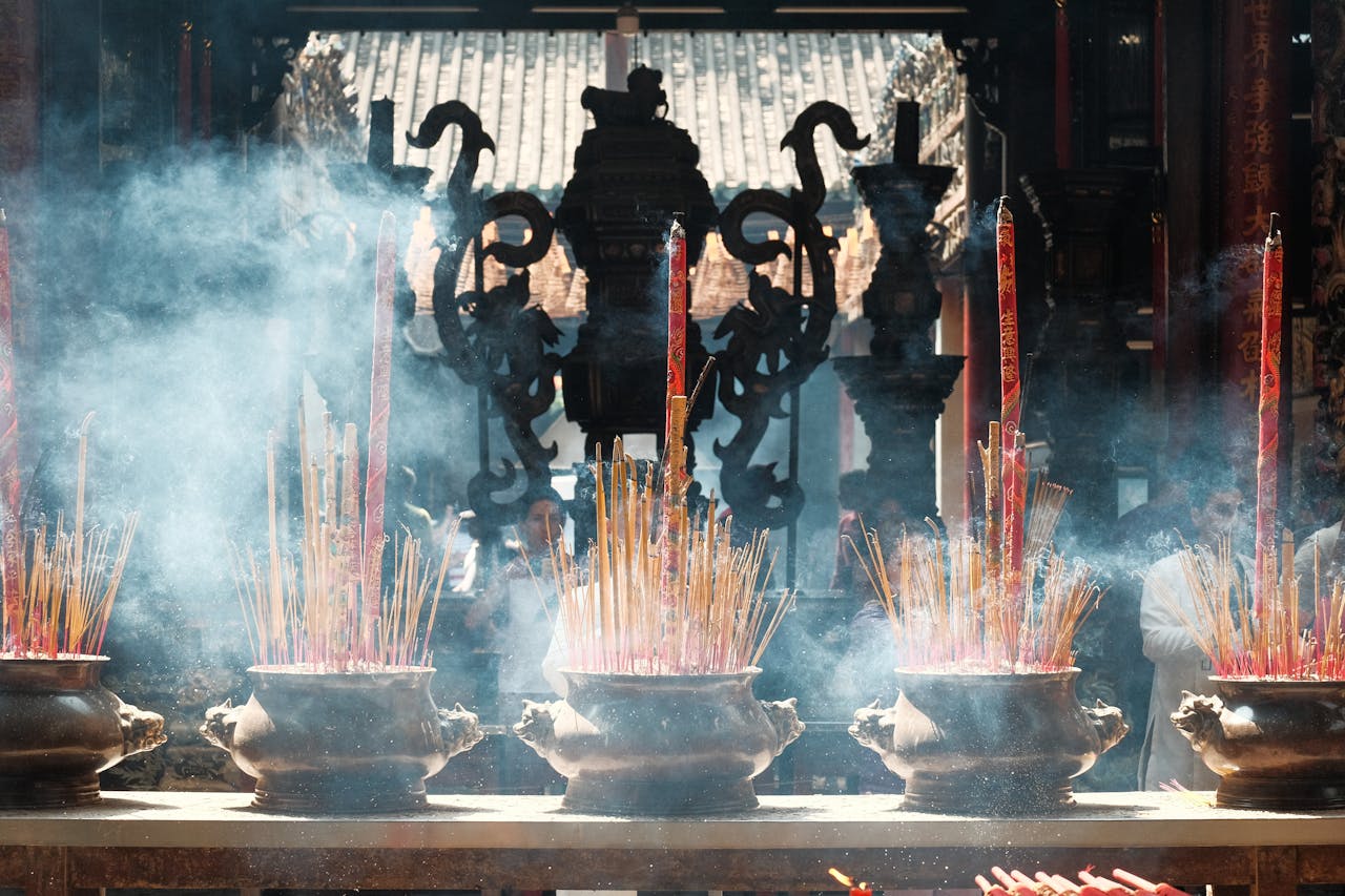 brand-02 Incense burning during a ceremonial worship at a Vietnamese temple, vibrant smoke fills the air.