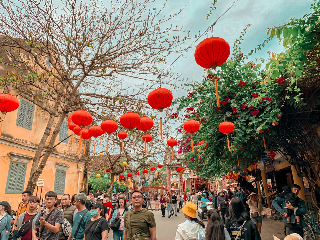 creative-03 Colorful street scene with red lanterns and crowds during Lunar New Year festival.