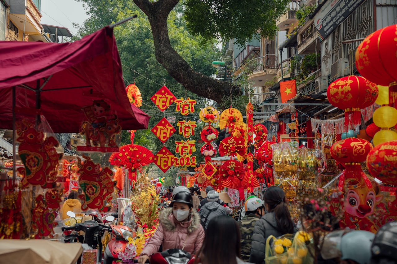 brand-01 Bustling Tết festival market with lanterns and decorations in a vibrant Vietnamese street.